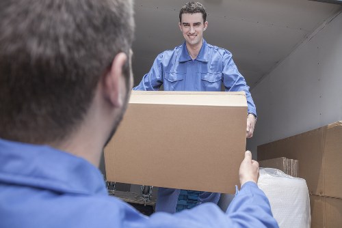 Local Thamesmead moving team handling furniture and boxes near residential flats