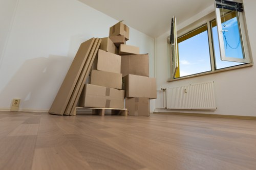 Moving team handling furniture access in a Thamesmead apartment block
